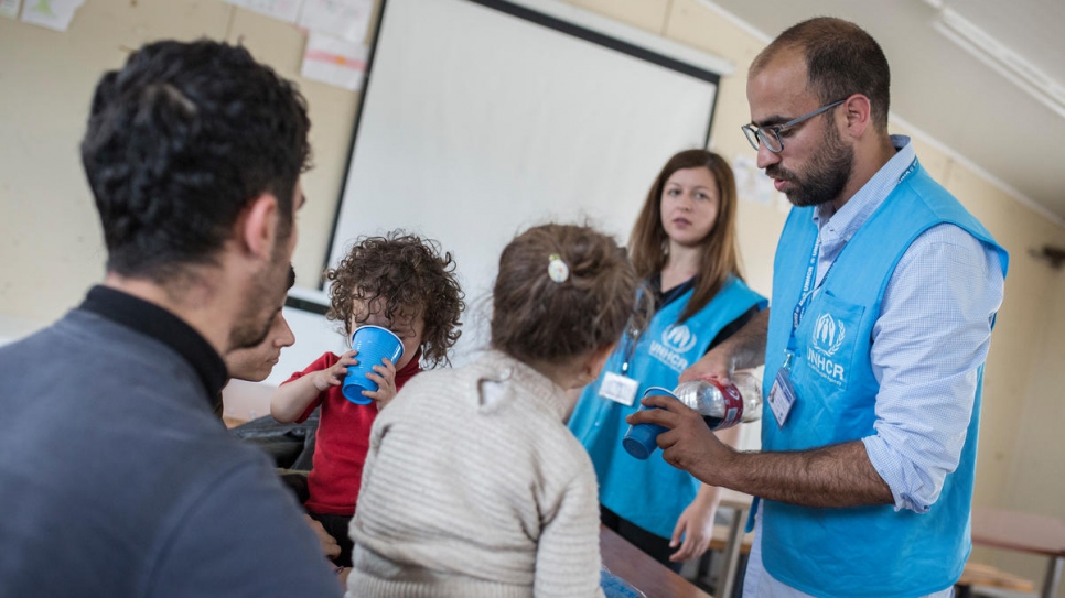UNHCR staff welcome refugees and migrants at the reception centre in Fylakio.