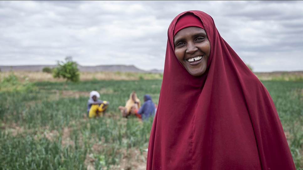 Refugee farmer Kaha Abdula stands beside irrigated crops in Melkadida, Ethiopia
