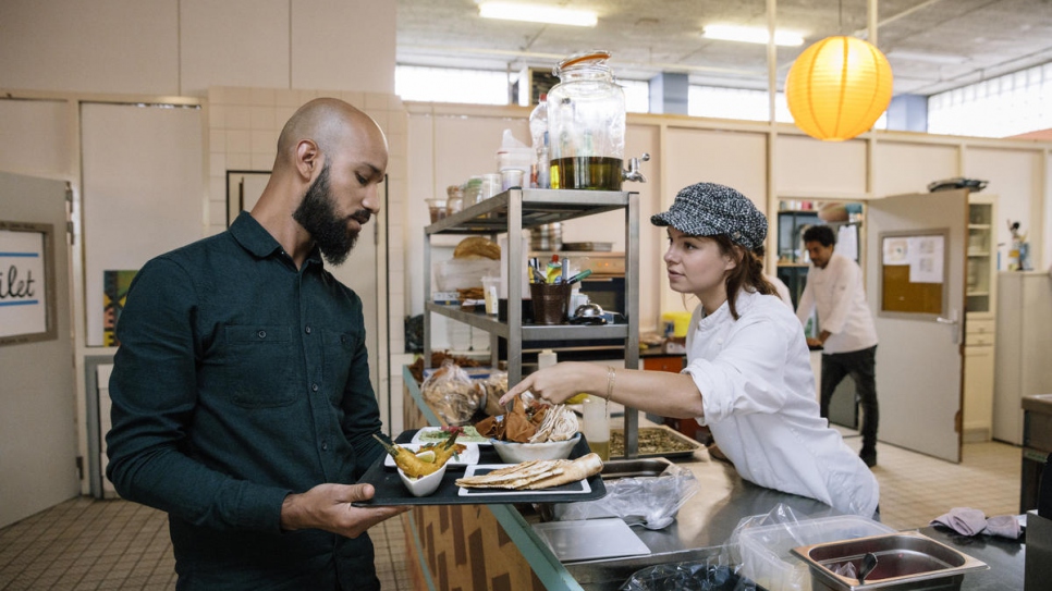 Floor manager Hayder Al Saadi talks to chef Rosah van Schendelen in the kitchen of A Beautiful Mess restaurant.