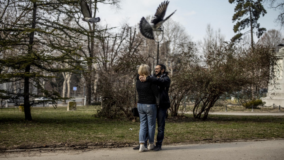 Mawaheb and Ida hug in a park in Belgrade. After fleeing Syria, he found safety in Serbia, then love and work as a software developer.