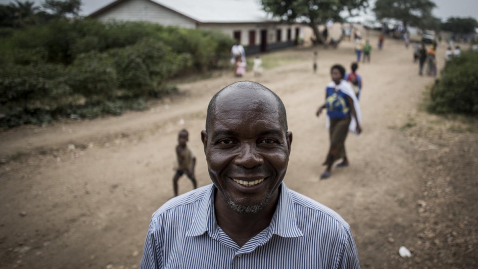 Rights activist Evariste Mfaume (centre) poses for a portrait at Lusenda refugee camp, the Democratic Republic of the Congo.