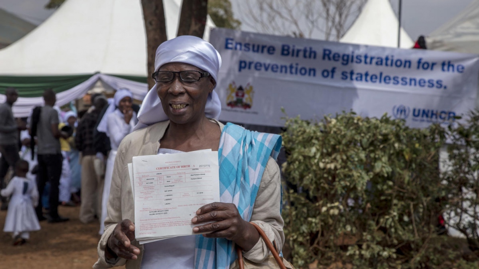 Emma's grandmother proudly holds her great-grandchildren's new birth certificates. 