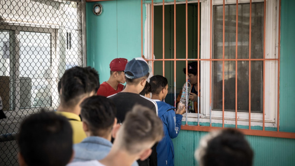 Unaccompanied boys from Afghanistan and Syria queue for a meal in Section A of the Moria reception centre.