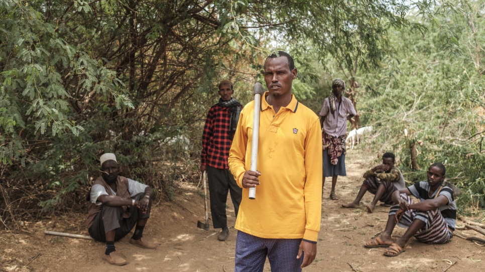 Aden Abdullahi Ahmed (centre) stands with members of the Dollo Ado cooperative among prosopis trees near the border with Somalia.