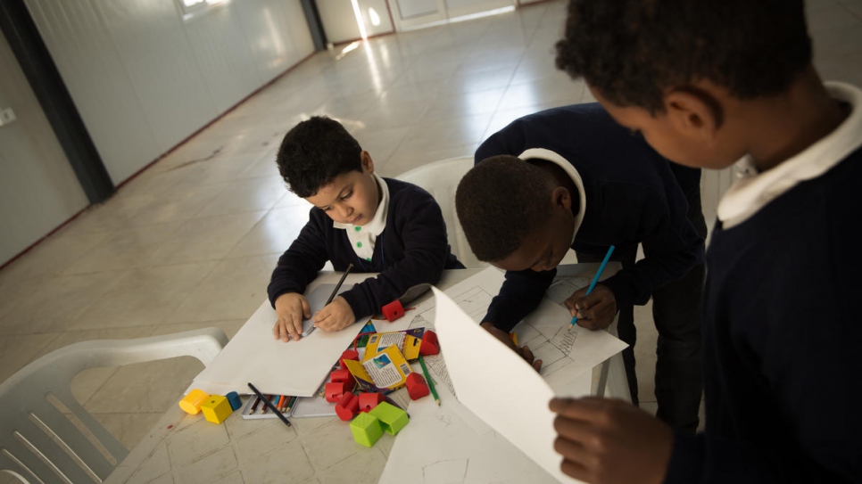 Children are encouraged to share their experiences through drawing.