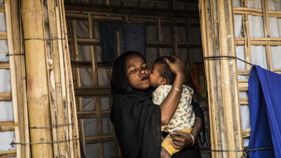 Rahima Khatun hugs her son Mohammad Arafat in her shelter, in Camp 1 West, Kutupalong. Cox's Bazar, Bangladesh.