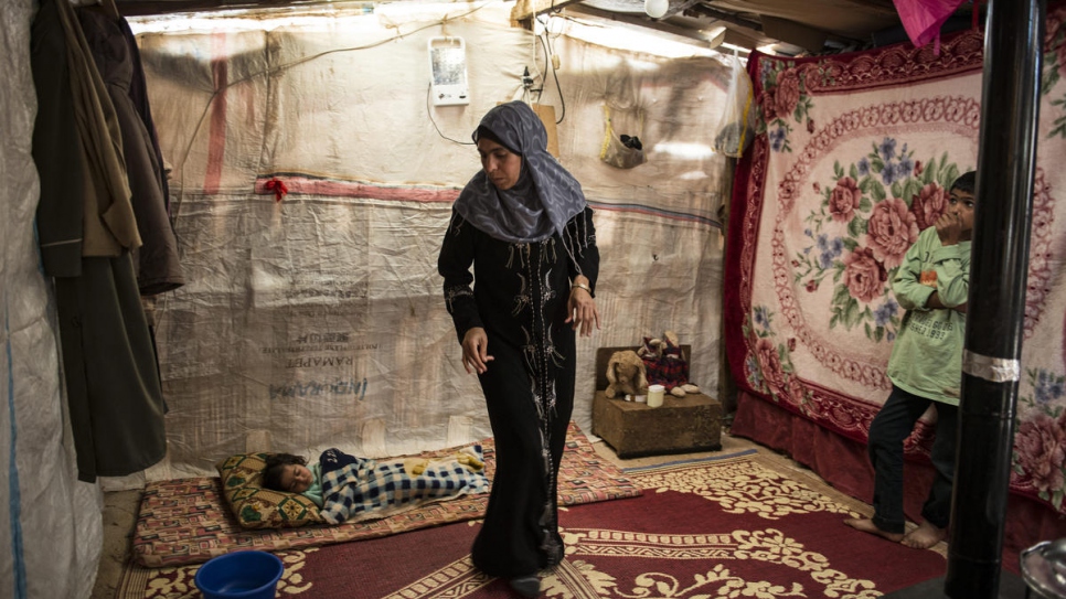 Archive photo of Syrian refugee Hasna in her tent in the Bekaa Valley, Lebanon, in March 2014. 
