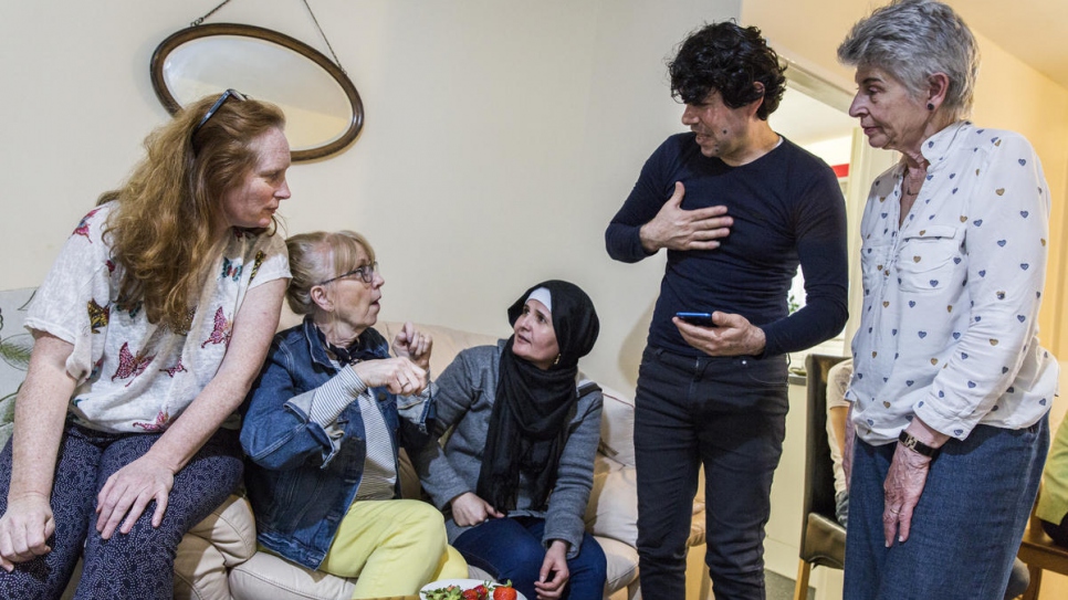 "When I started this, my bigger dream was that this could be a great model for social change."

Community support volunteers Felicity Brangan (left), Colette Pritchard (second left), and Caroline Malkin (right) use a phone to help Noura and Sakkar Daour translate Arabic into English at the Daour's new home in Bury, north-west England. Felicity, an English teacher and former actor, inspired the community with the idea of offering a refugee family a home.