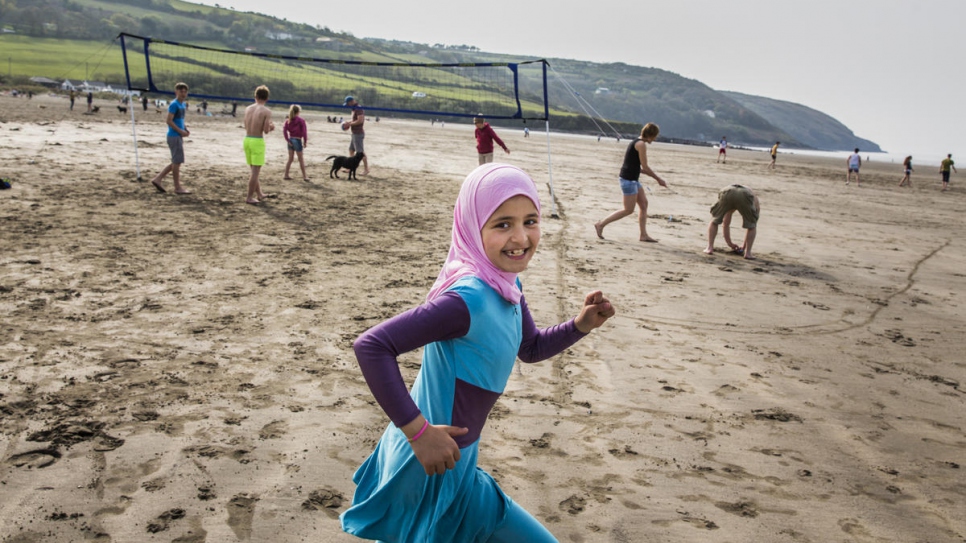 Nine-year-old Sara Alchik plays at a beach in south Wales. Sara has lived in Cardigan for over a year and speaks fluent Welsh.