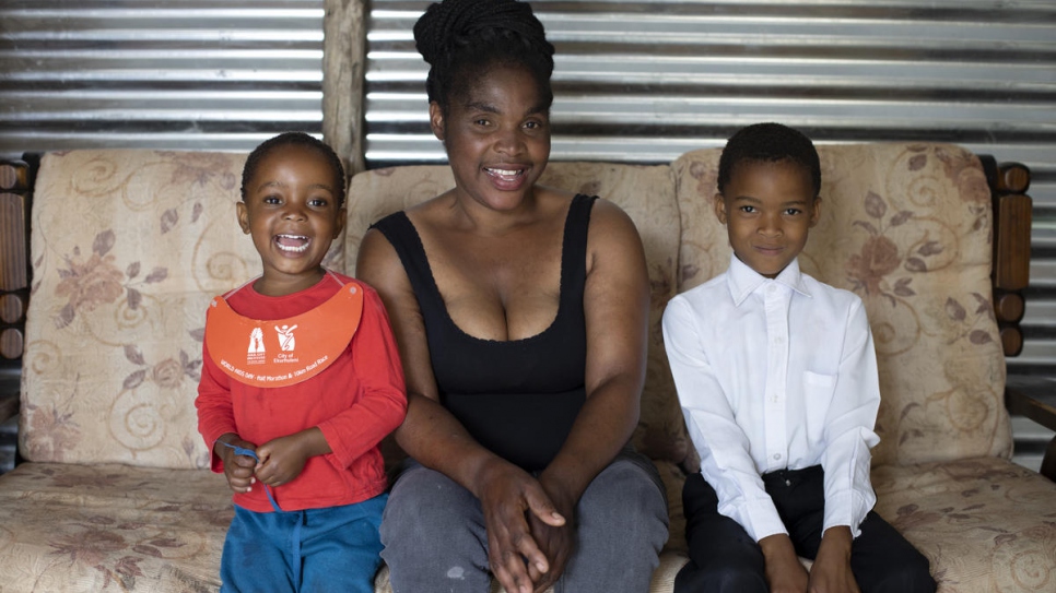 Mpho Modise poses with her two daughters Keitumestsi and Thabang, in the small shack they call home in Brits, South Africa. 