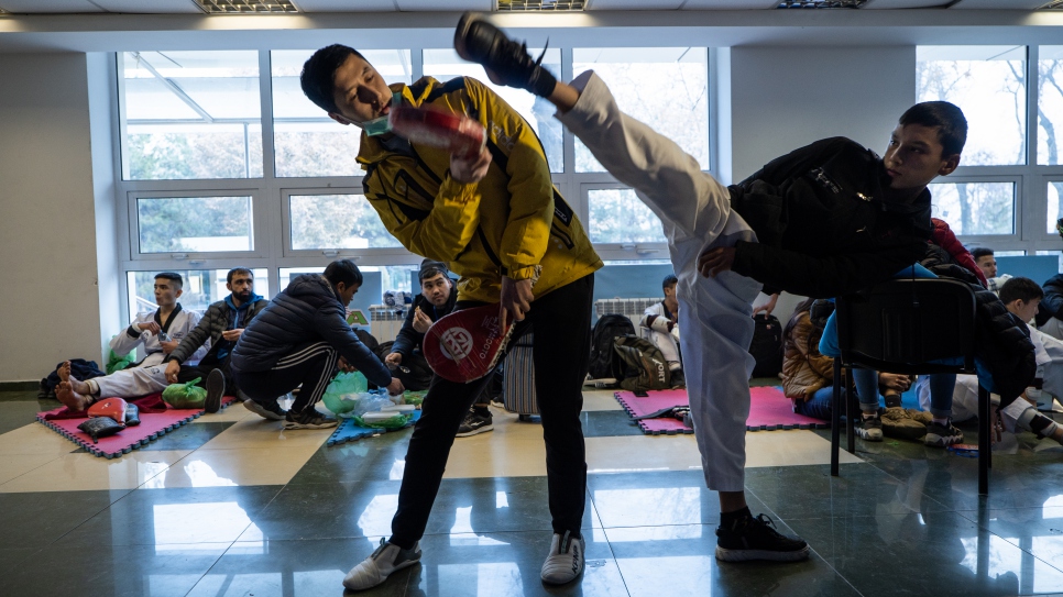 Mukhamadjon and his student prepare for a fight at Uzbekistan's Taekwondo Federation.
