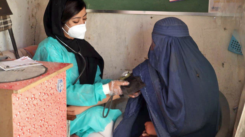 Marzila examining a patient at her clinic in Quetta, Pakistan.