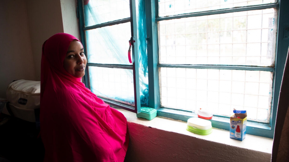 Zainab poses for a portrait in the home where the family has lived since being evacuated from Libya.
