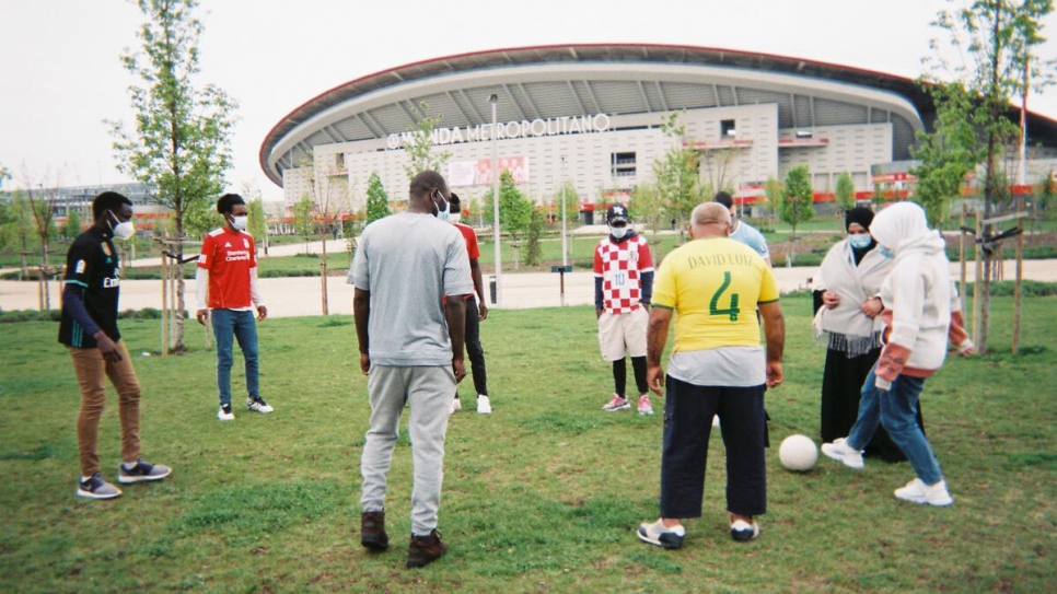 Refugees perform training drills outside the Wanda Metropolitano Stadium in Madrid.