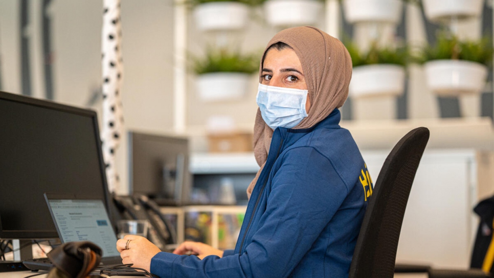 Lajan, a refugee from the Kurdistan region of Iraq, works at a computer at the IKEA Zagreb store.
