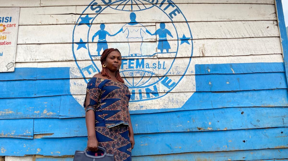 Rosette* a survivor of gender violence stands with her father outside their home in Masisi, the Democratic Republic of the Congo. 
