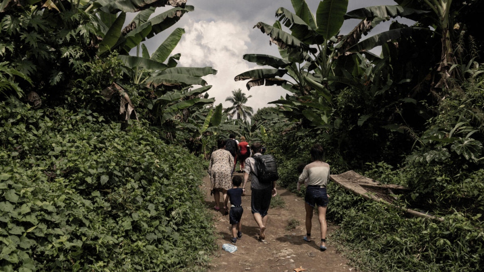A group of refugees and migrants walks towards the village of Canaan in the far south of Panama after crossing the Darien Gap.