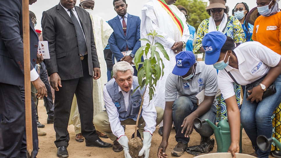 Grandi plants a tree as part of a reforestation project at the site designed to combat desertification.