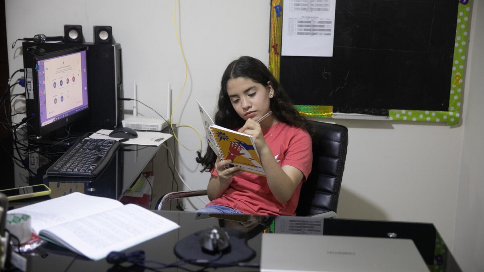 María, a young Venezuelan participant of "Chamas en Acción", studies at her house in Lima, Peru.
