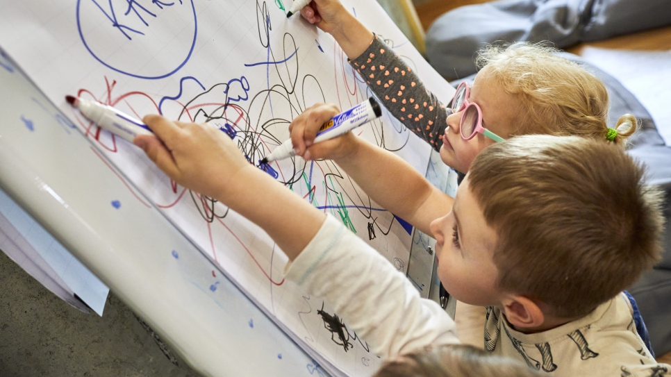 Young Ukrainian refugees draw together at Zi de Bine, which means "Day of Good".