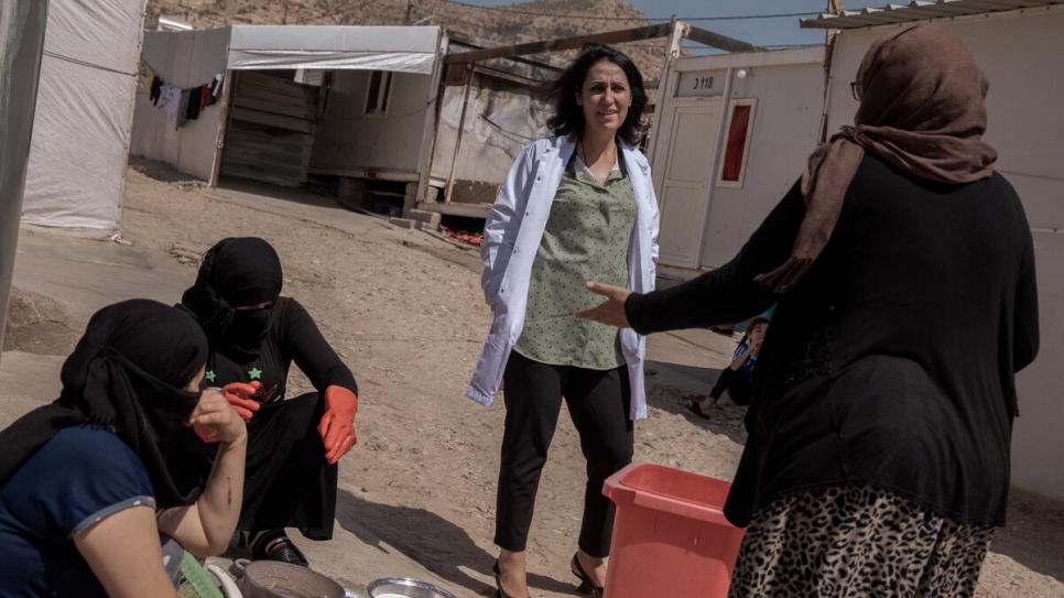 Dr. Nagham Hasan speaks with residents of Rwanga camp, which is home to some 2,442 Yazidi families and 104 survivors of ISIS enslavement.