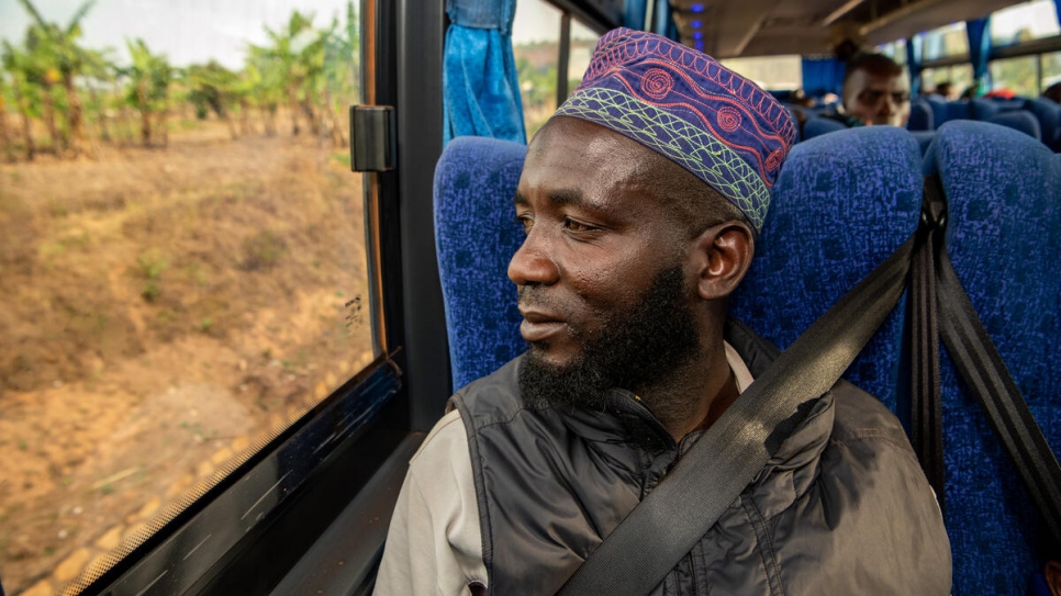 Ramadhani Chongera, 40, returns home to Burundi on a bus after spending years living as a refugee in Tanzania with his wife and their three children. 