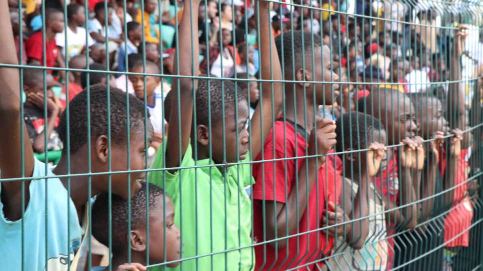 Children watch the Integrated Football Club of Lôvua compete in their first provincial championship match in Dundo.