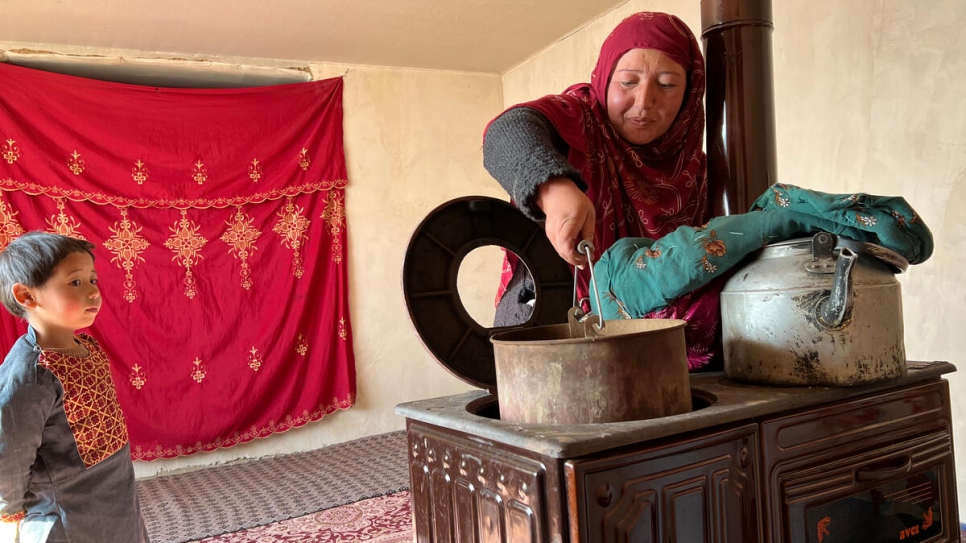 Winter cash assistance allowed widow and mother of six, Sara, to buy a wood-burning stove for cooking and heating the family's one-room home.