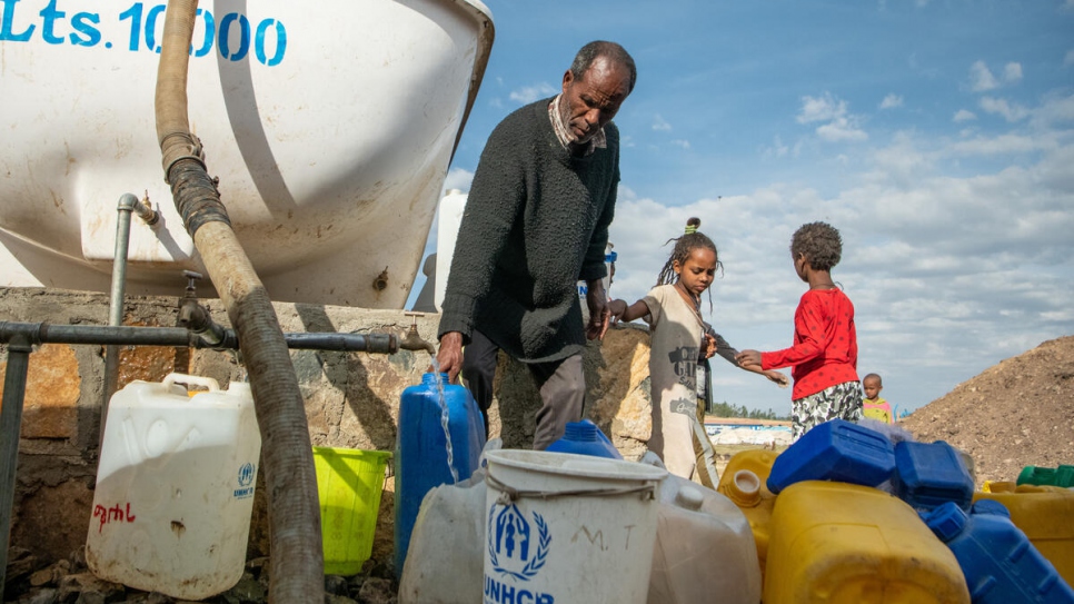 An Eritrean refugee fetches water for his family at Alemwach.