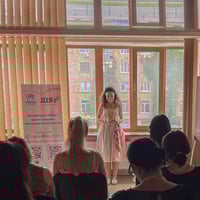 A woman is making a speech during the event