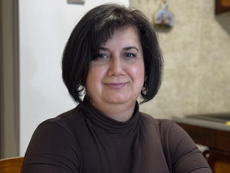 Ryta sitting in her kitchen in the rented apartment 