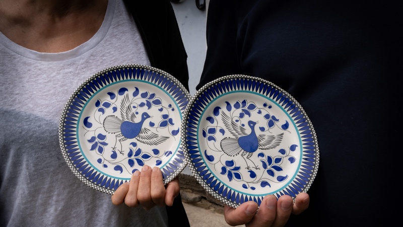 A woman holding plates