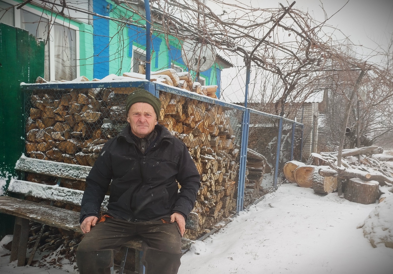 Anatolii in front of his house 