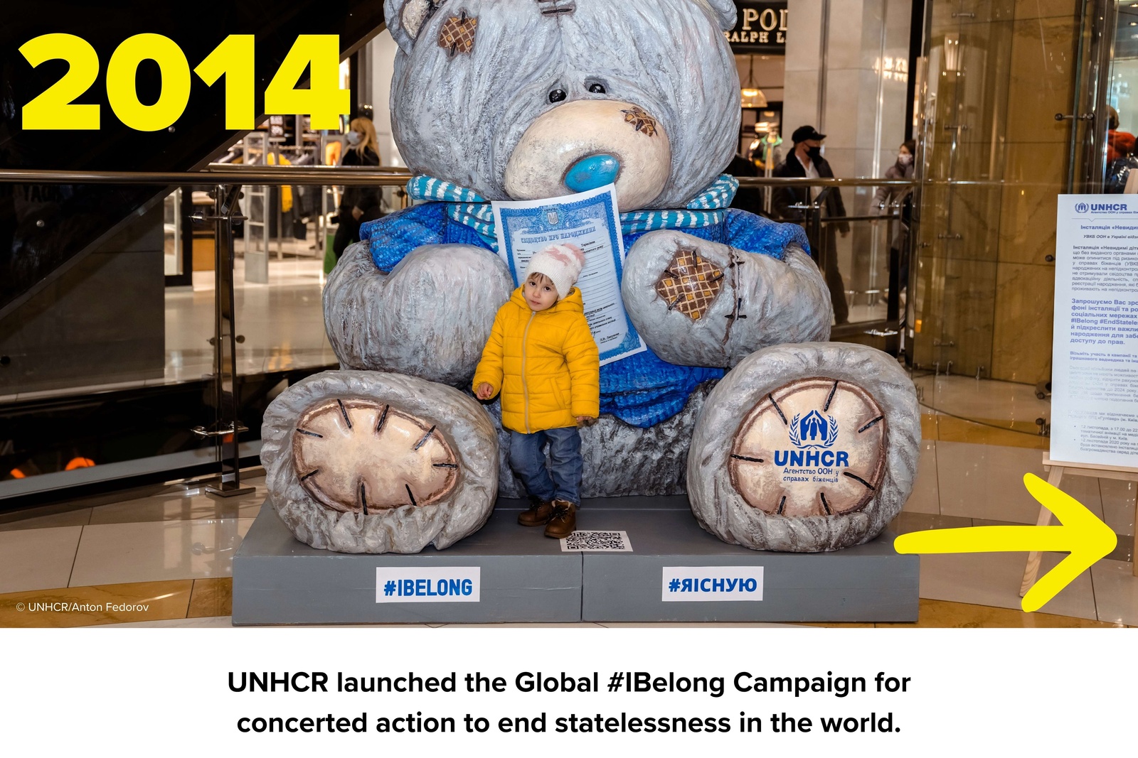 Girl standing in front of the huge bear for IBelong campaign.