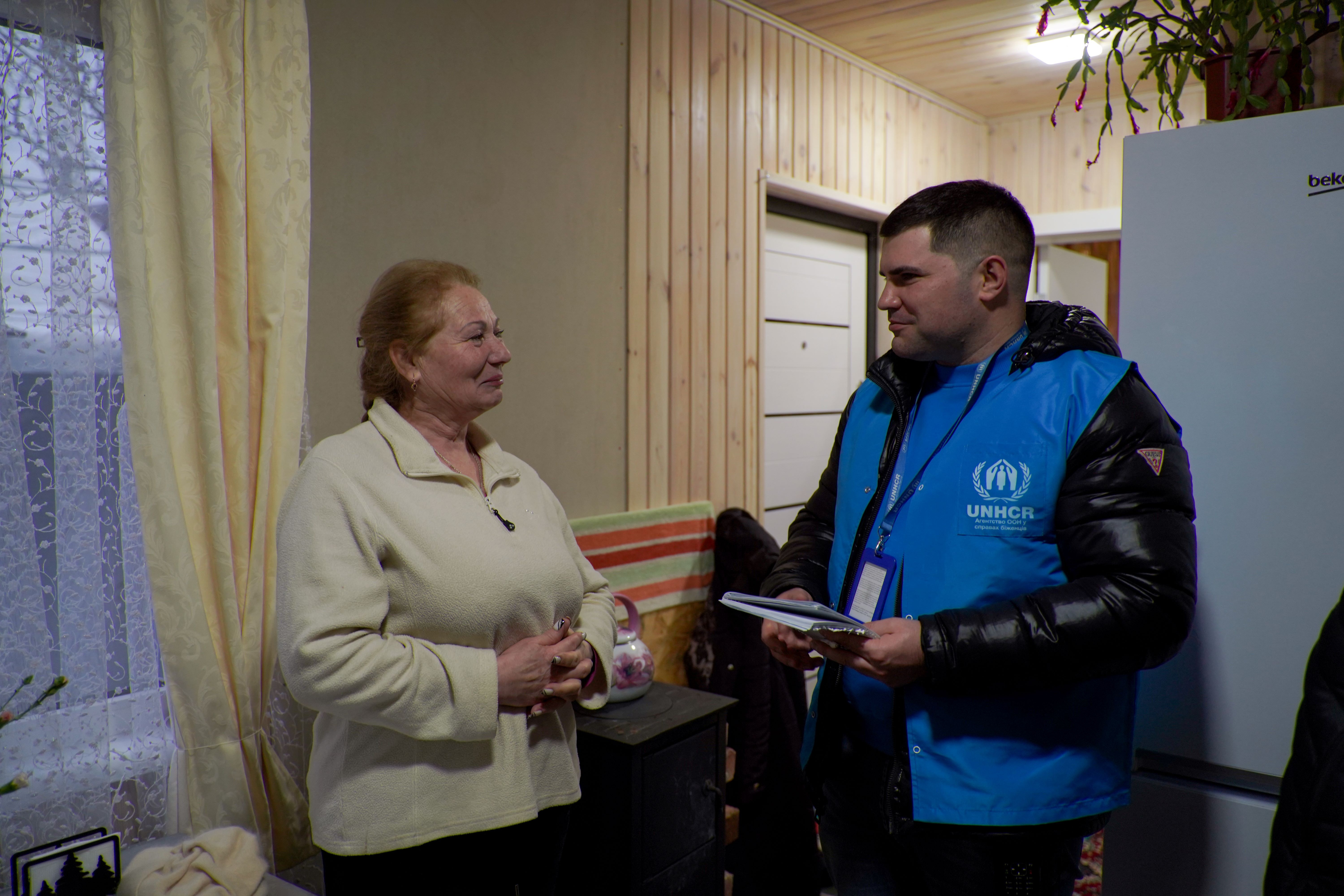 UNHCR staff is talking to the war affected woman