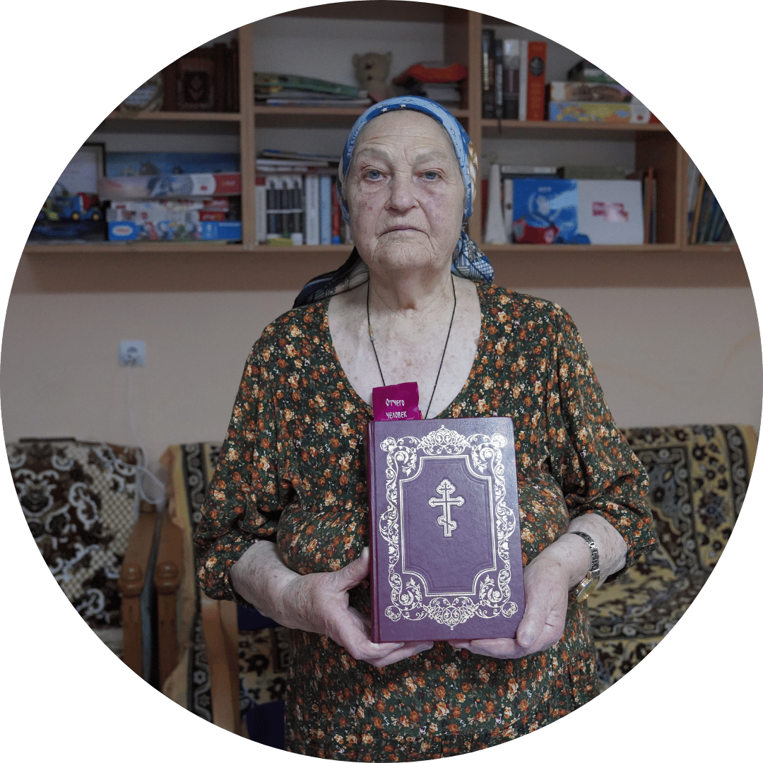 An older Ukrainian woman poses with her bible