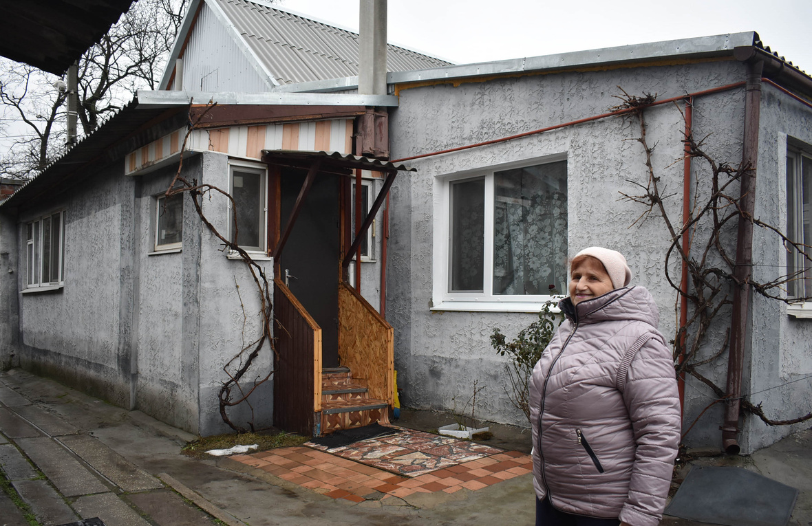 Woman in front of her house