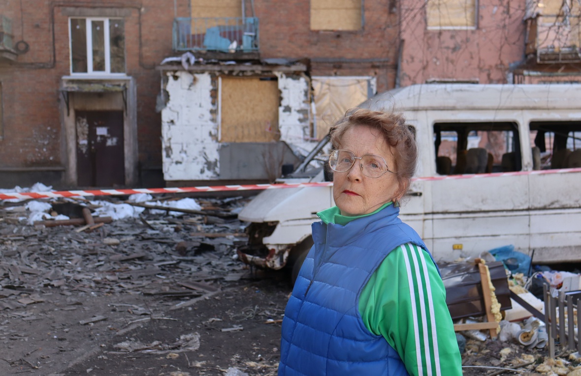 Liudmyla, 68, stands outside her damaged apartment building in Kryvyi Rih