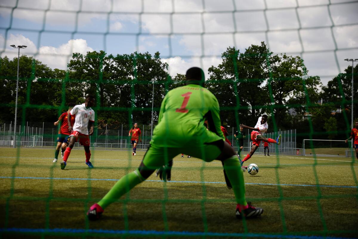 A player from the Spanish team aims for the Maltese goal at the Unity Cup in Frankfurt, Germany. The tournament was launched by UEFA and UNHCR to promote inclusion through sport. The 16 competing teams consist of refugee and host community players.