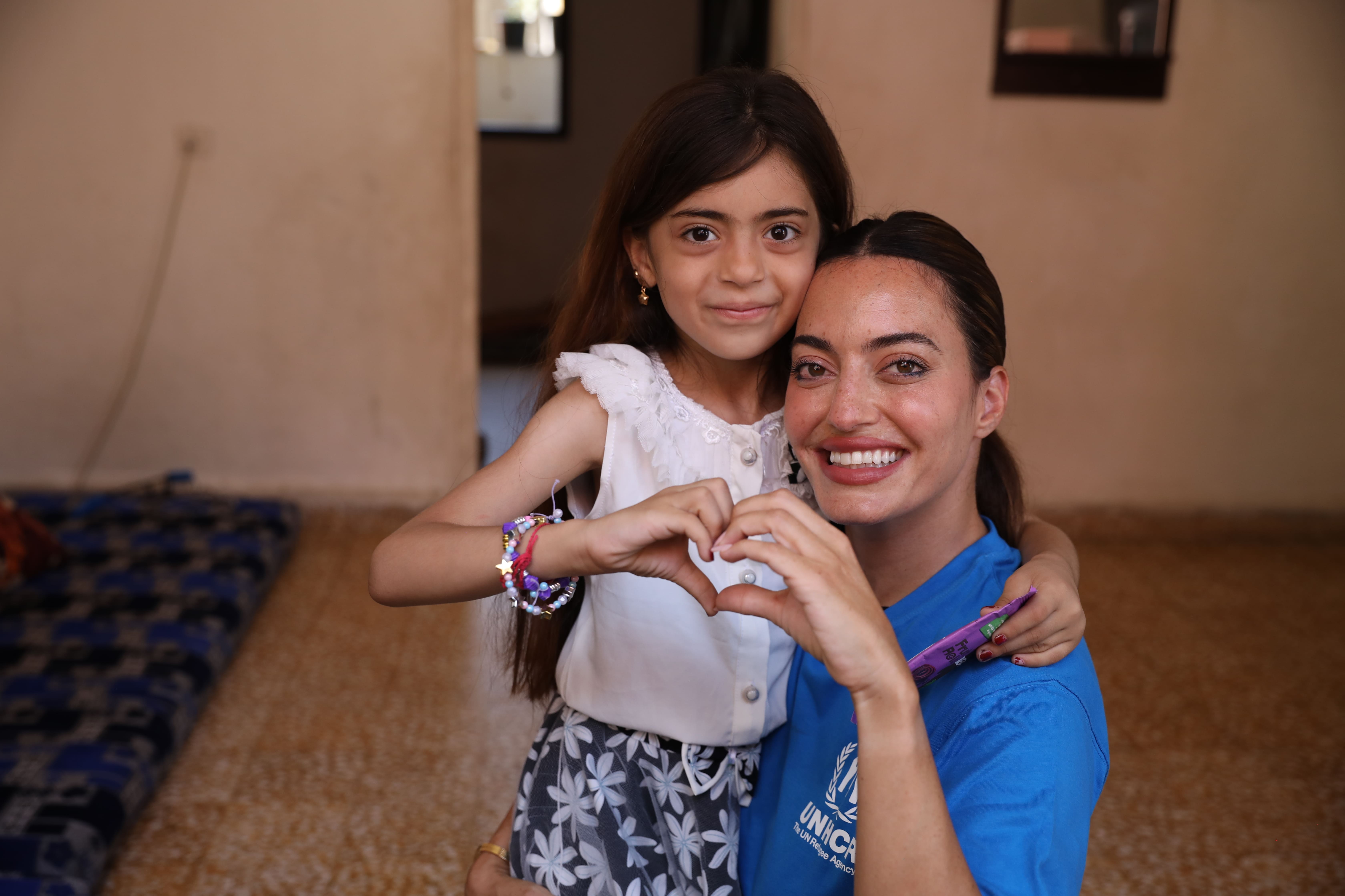 Karen Wazen and Rimas hugging and making a heart with their hands.