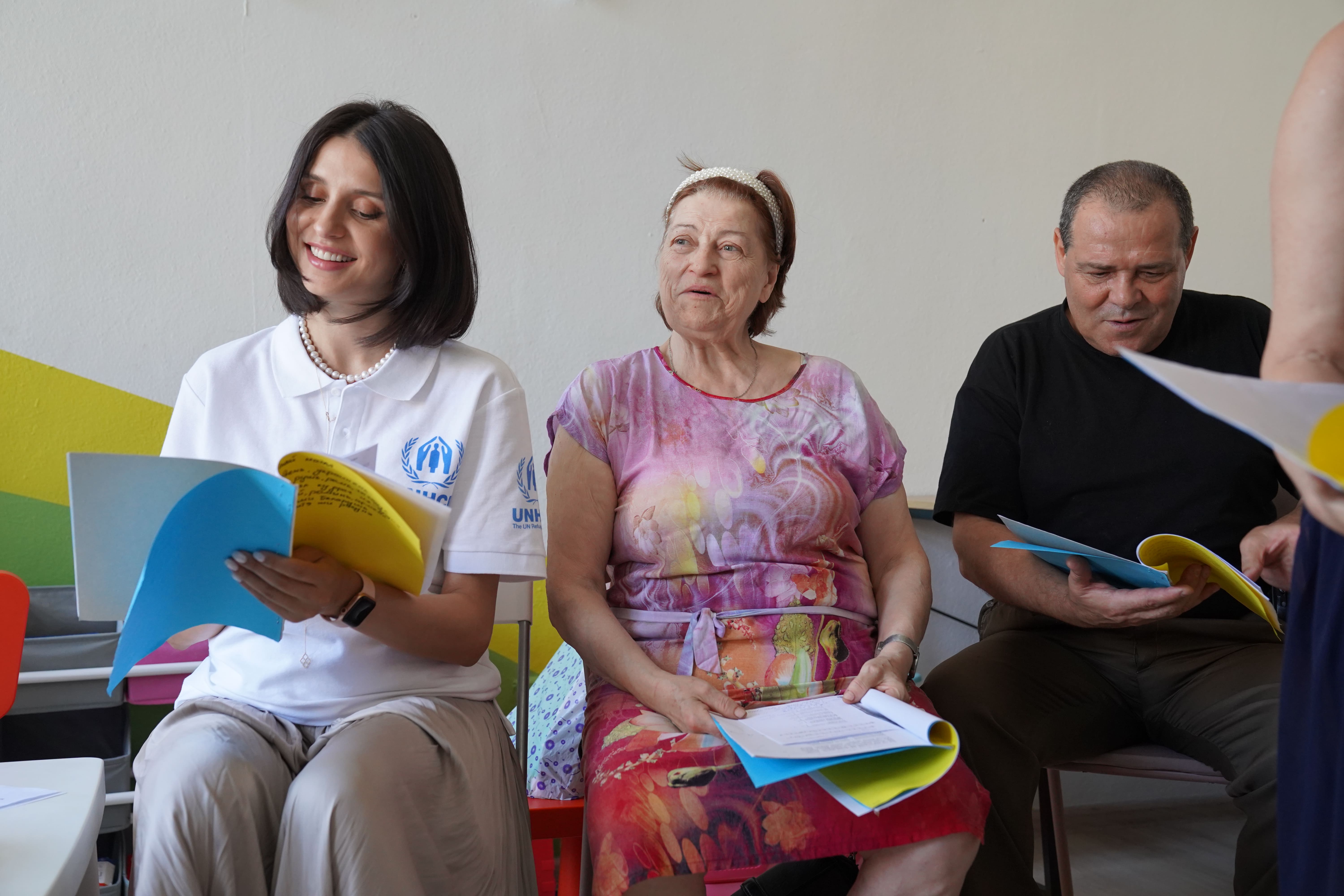Valentina Naforniță smiling and reading lyrics on printed paper
