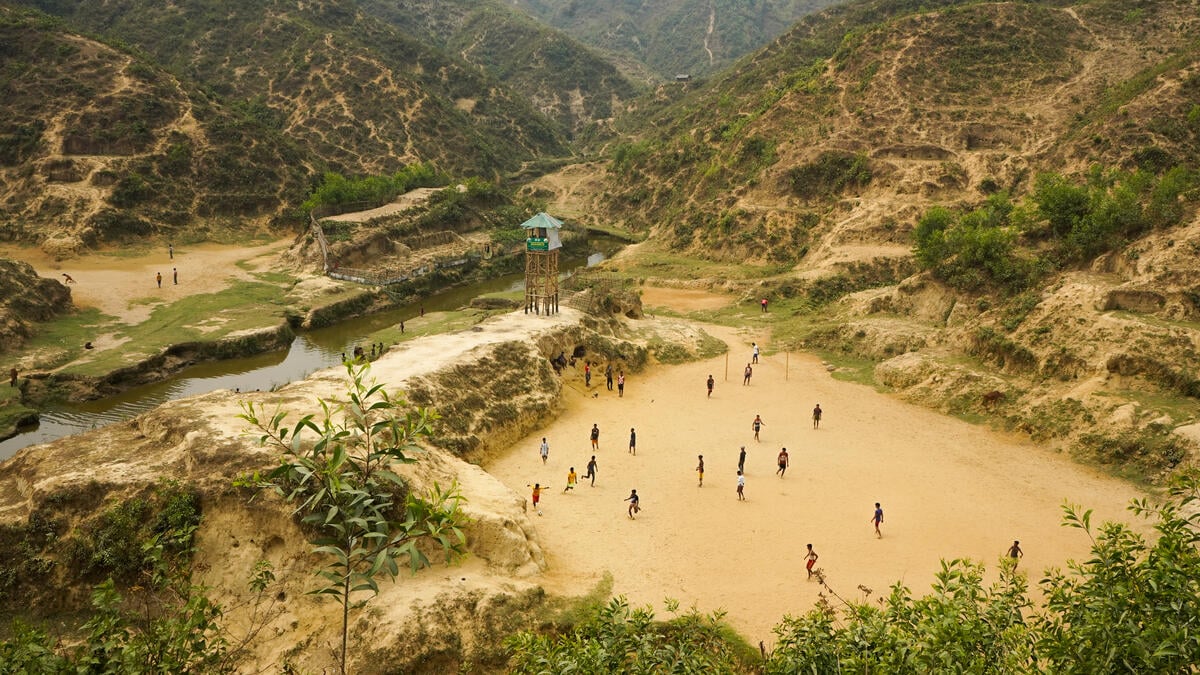 Boys playing soccer at open field in camps