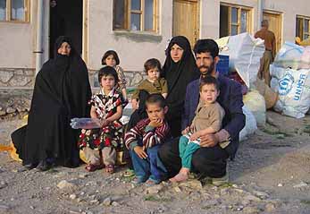 An Afghan family waits for transport home at the Gazergah Transit Distribution Centre in Herat.