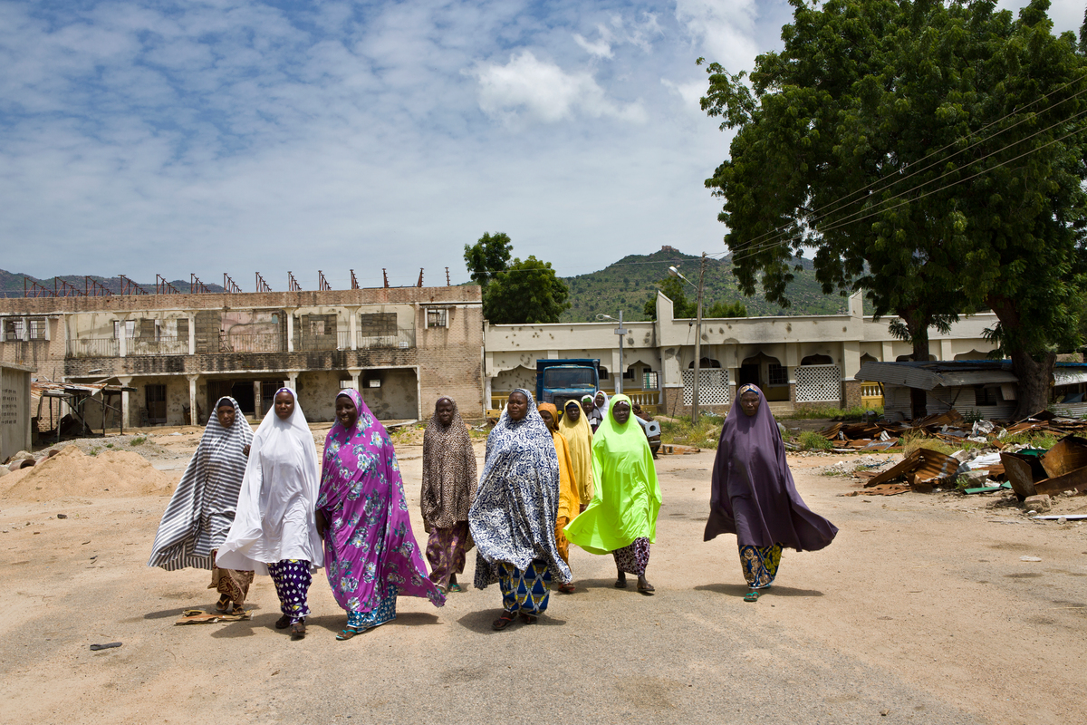 Women walk along a street in Gwoza, Nigeria.