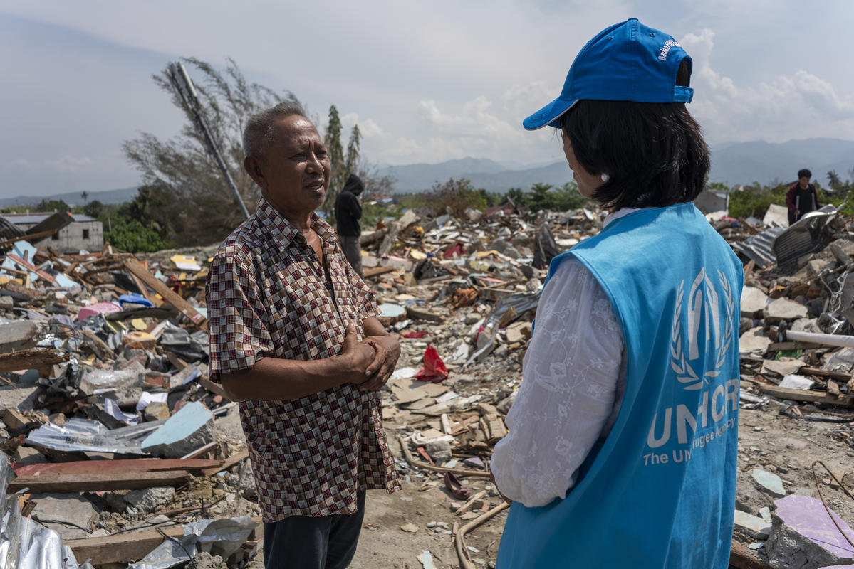 Indonesia. UNHCR staff with survivor of earthquake