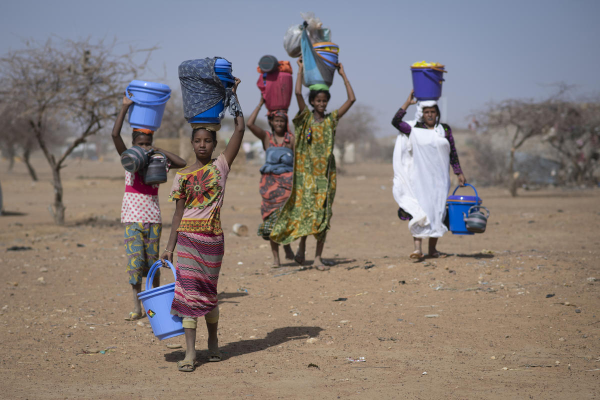 Malian refugees collect aid items at Goudoubo camp, Burkina Faso, February 2020.