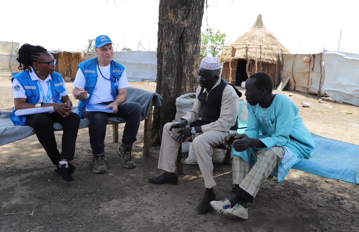 South Sudan. UNHCR staff with fathers of two of the six victim children of the UXO blast in Maban