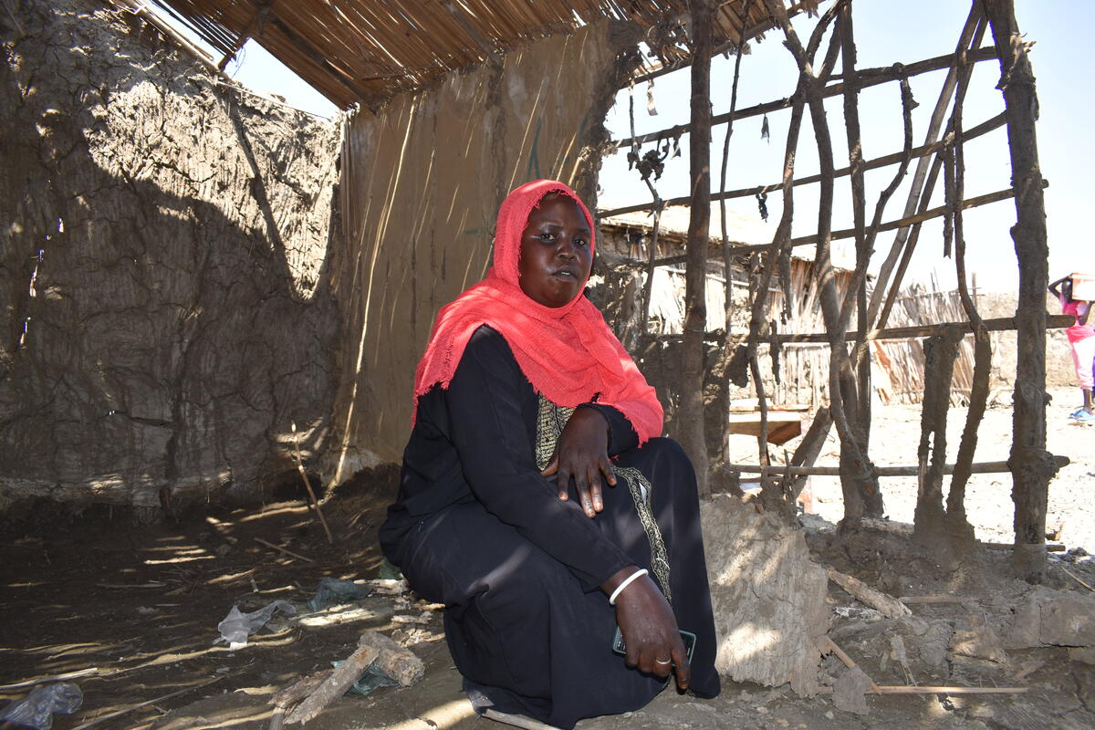 Sudan. Nyalan Goldit inside her destroyed shelter.