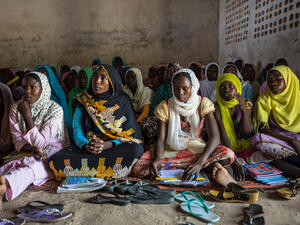 Chad. Refugee mother and her children study together