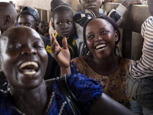 Central African Republic. Returnees sing and laugh on the boat back home
